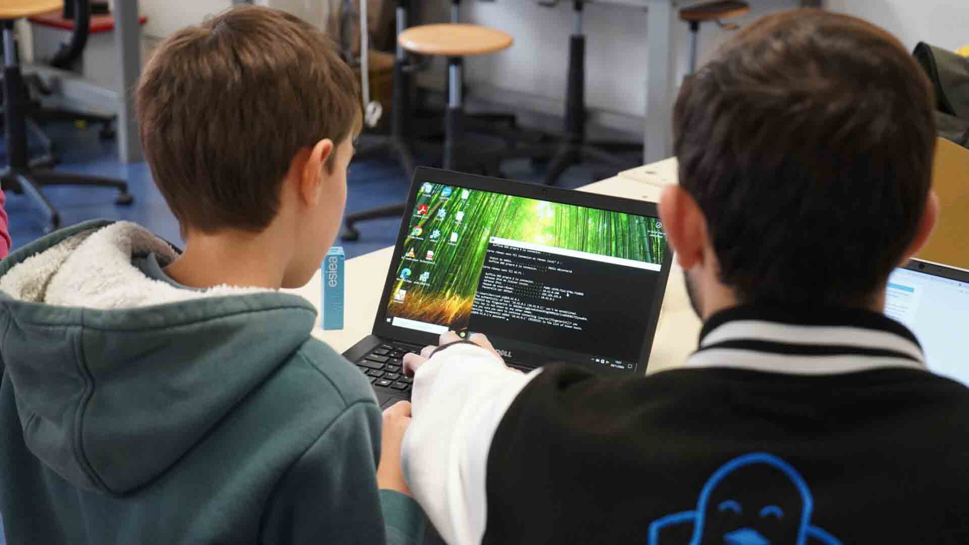 Etienne programmant son invention avec un étudiant de l'ESIEA